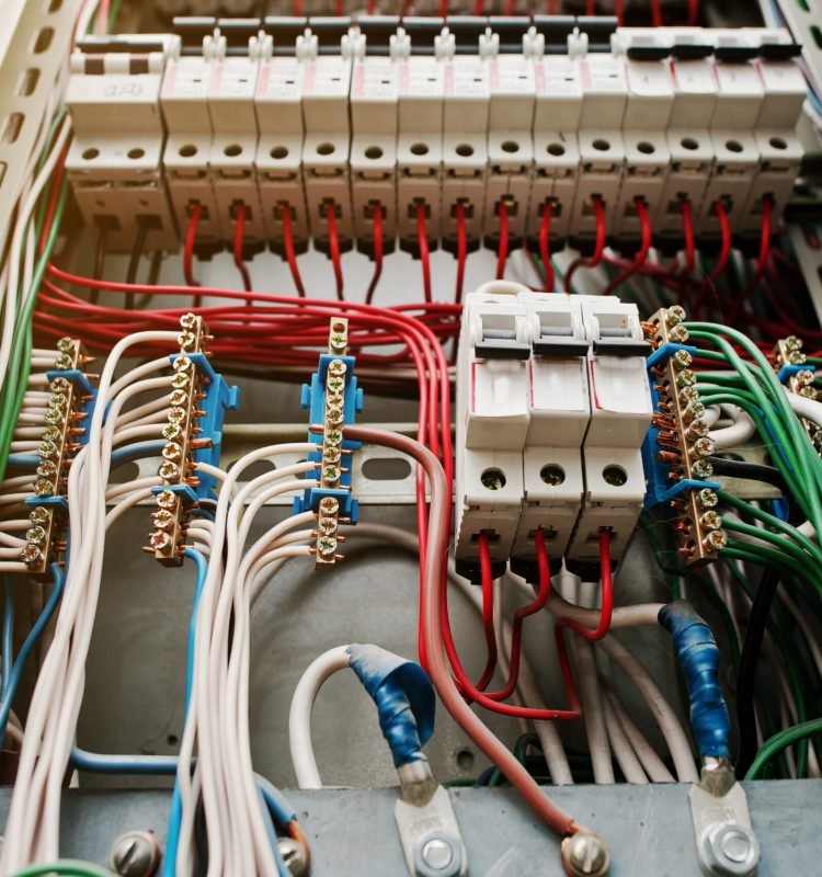 Close up view of electrical panel with fuses and contactors.