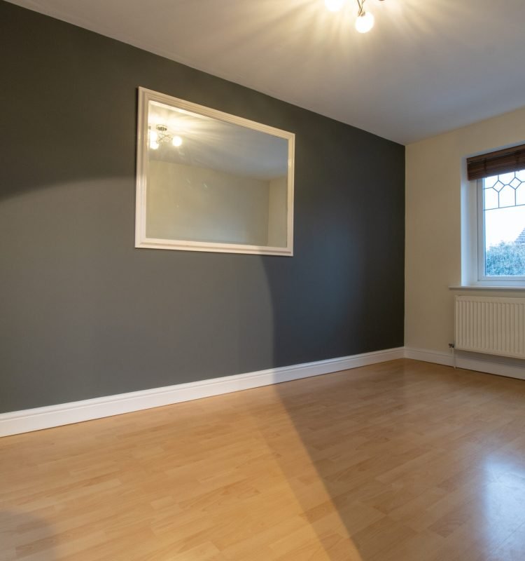 empty-room-with-wood-flooring-and-large-mirror-2026-04-15-05-06-27-utc