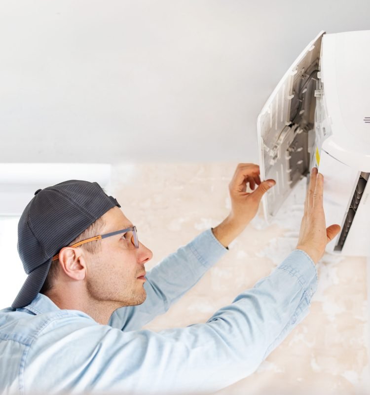man-repairs-air-conditioner-at-home-2026-03-24-11-17-32-utc