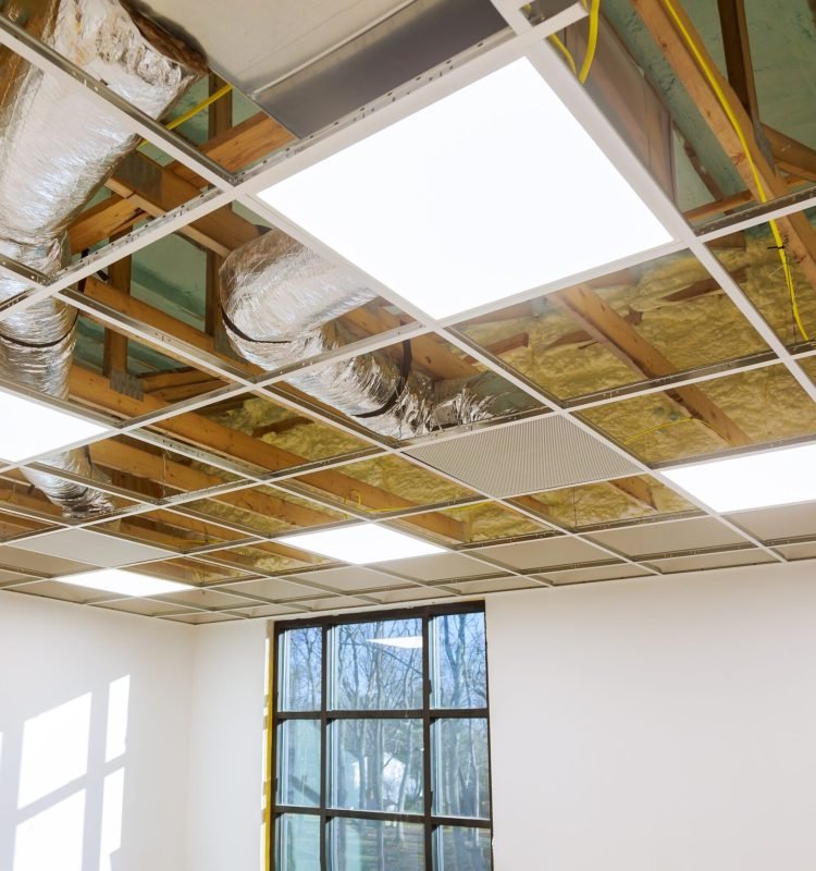 Air conditioning system attached to attic ceiling, foam plastic insulation of a new home HVAC vents being installed