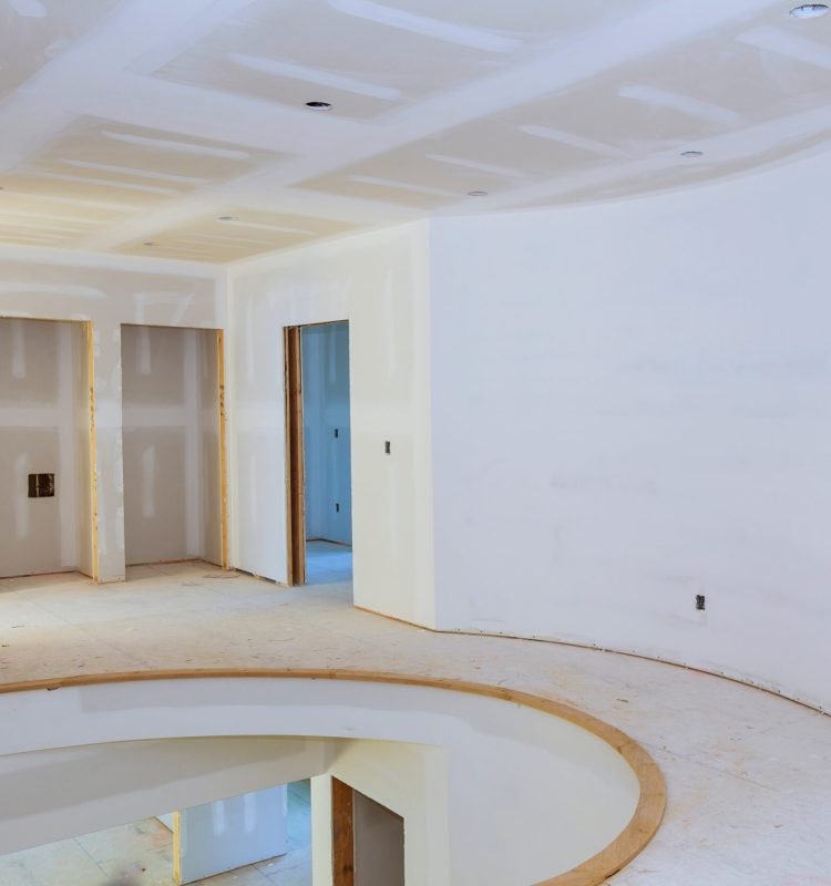 Walls of Interior construction of housing project with drywall installed and patched without painting applied